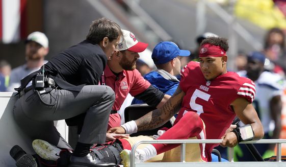 San Francisco 49ers quarterback Trey Lance (5) is carted off the field during the first half of an NFL football game against the Seattle Seahawks in Santa Clara, Calif., Sunday, Sept. 18, 2022. (AP Photo/Tony Avelar)