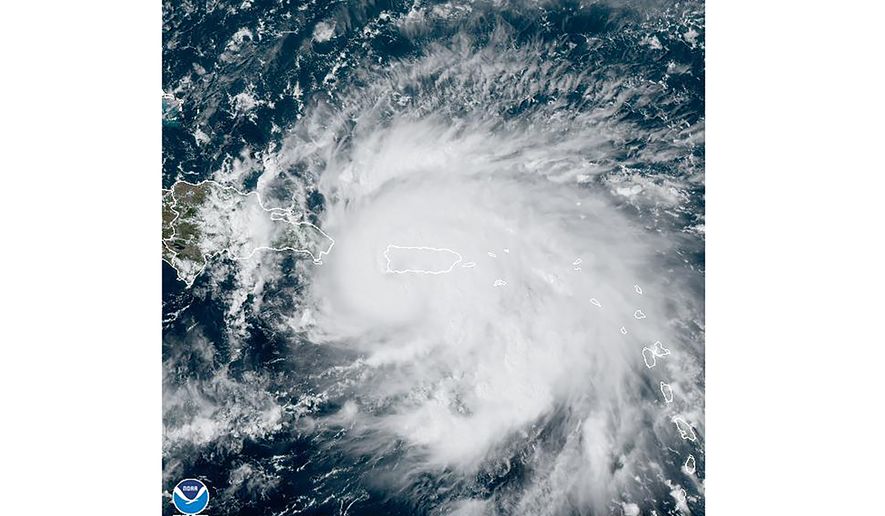 This satellite image provided by NOAA shows Hurricane Fiona in the Caribbean on Sunday, Sept. 18, 2022. The eye of newly formed Hurricane Fiona is near the coast of Puerto Rico — and it has already sparked an island-wide blackout and threatens to dump “historic” levels of rain. (NOAA via AP)