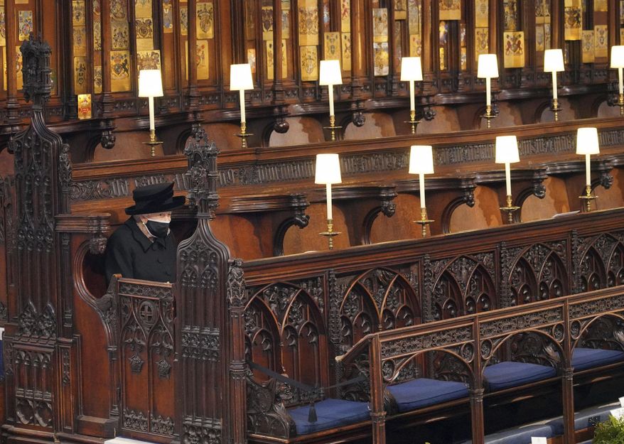 Britain&#39;s Queen Elizabeth II sits alone in St. George&#39;s Chapel during the funeral of Prince Philip, the man who had been by her side for 73 years, at Windsor Castle, Windsor, England, Saturday, April 17, 2021. In retrospect, it seems Queen Elizabeth II was preparing us all along for her death. Whether it was due to age, ill health or a sense that the end was near, she spent much of the last two years tying up loose ends, making sure the family firm would keep ticking along. (Jonathan Brady/Pool via AP, File)