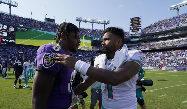 Miami Dolphins quarterback Tua Tagovailoa and Baltimore Ravens quarterback Lamar Jackson greet each other at the end of an NFL football game, Sunday, Sept. 18, 2022, in Baltimore. The Dolphins defeated the Ravens 42-38. (AP Photo/Julio Cortez)