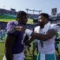 Miami Dolphins quarterback Tua Tagovailoa and Baltimore Ravens quarterback Lamar Jackson greet each other at the end of an NFL football game, Sunday, Sept. 18, 2022, in Baltimore. The Dolphins defeated the Ravens 42-38. (AP Photo/Julio Cortez)