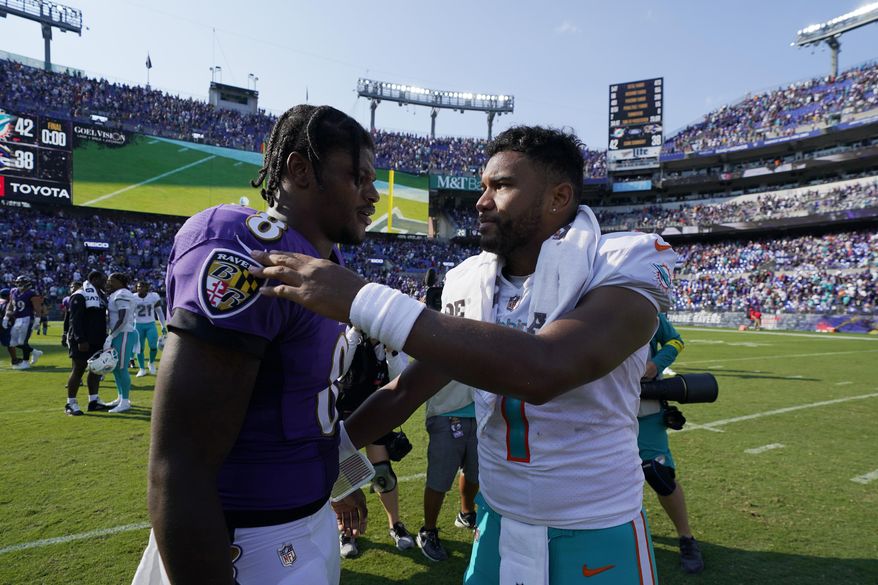 Miami Dolphins quarterback Tua Tagovailoa and Baltimore Ravens quarterback Lamar Jackson greet each other at the end of an NFL football game, Sunday, Sept. 18, 2022, in Baltimore. The Dolphins defeated the Ravens 42-38. (AP Photo/Julio Cortez)