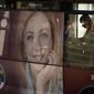 A poster of Italy&#39;s candidate premier Giorgia Meloni stands on the side of a bus in Rome, Friday, Sept. 16, 2022. Italy could be on the verge of electing its first woman premier. That prospect delights some Italian women, but others are dismayed by her conservative beliefs and policies. If opinion polls prove on the mark, Giorgia Meloni and the far-right Brothers of Italy party she co-founded less than a decade ago will triumph in Sept. 25 elections for Parliament. (AP Photo/Alessandra Tarantino)