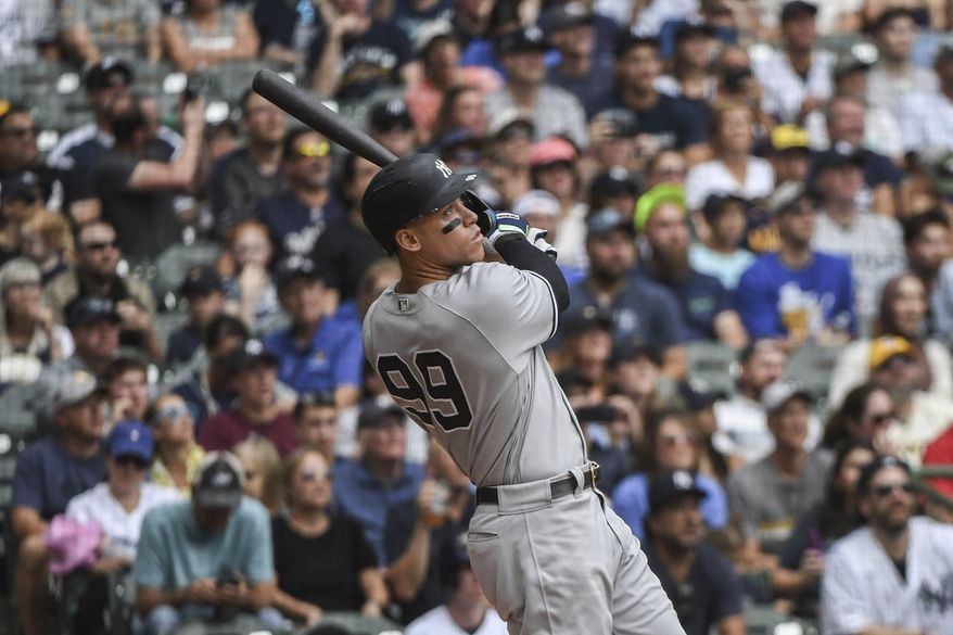 New York Yankees&#39; Aaron Judge hits his fifty eighth homerun during the third inning of a baseball game against the Milwaukee Brewers Sunday, Sept. 18, 2022, in Milwaukee. (AP Photo/Kenny Yoo)