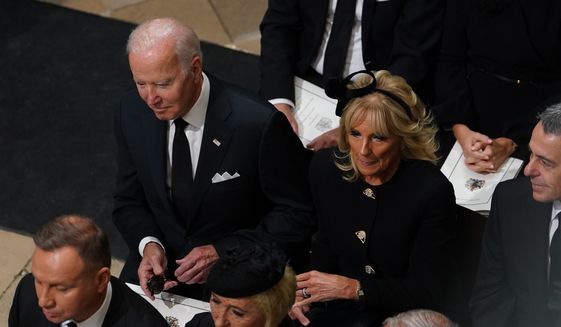 US President Joe Biden accompanied by the First Lady Jill Biden arrive for the State Funeral of Queen Elizabeth II, held at Westminster Abbey, London, Monday, Sept. 19, 2022. (Gareth Fuller/Pool Photo via AP)