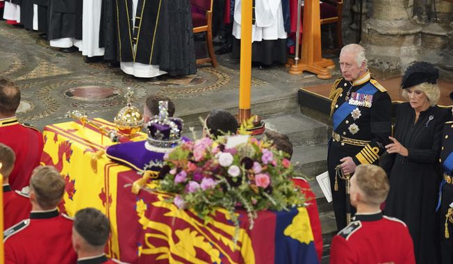 King Charles III, and the Queen Consort attend the funeral of Queen Elizabeth II at Westminster Abbey, in central London, Monday Sept. 19, 2022. The queen, who died aged 96 on Sept. 8, will be buried at Windsor alongside her late husband, Prince Philip, who died last year. (Dominic Lipinski/Pool via AP)
