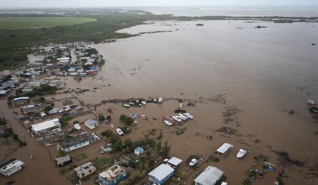 Homes are flooded on Salinas Beach after the passing of Hurricane Fiona in Salinas, Puerto Rico, Monday, Sept. 19, 2022. (AP Photo/Alejandro Granadillo)