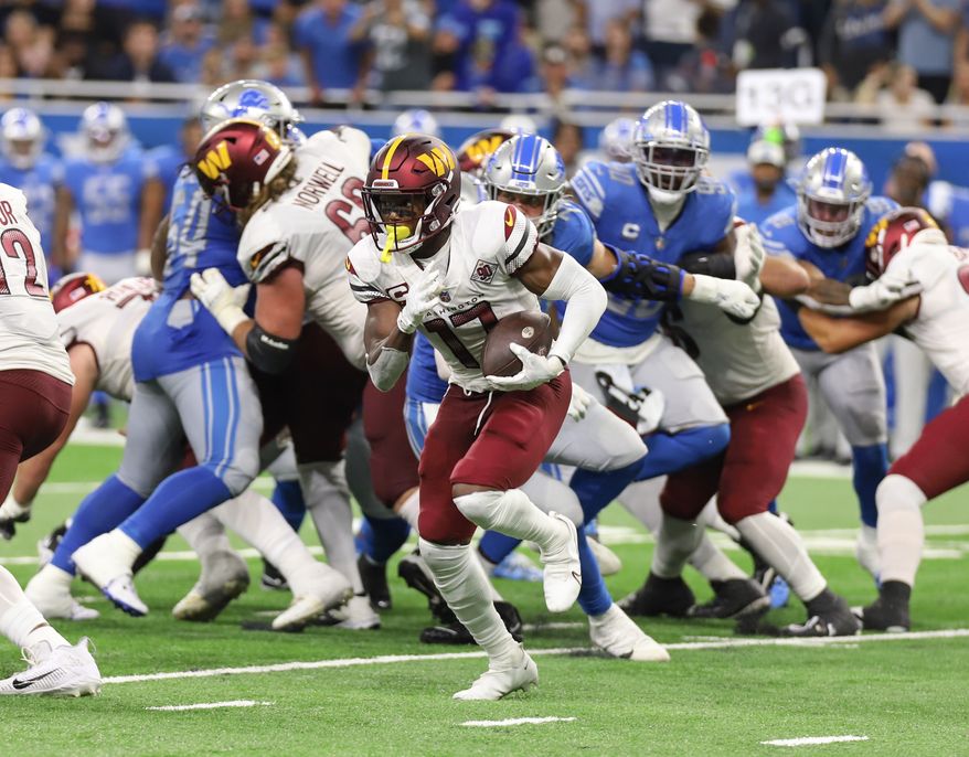 Washington Commanders&#39; WR Terry McLaurin (17) runs with the ball avoiding the tackle at the Washington Commanders vs the Detroit Lions at Ford Field in Detroit Michigan on September 18th 2022 (Photo: Alyssa Howell)
