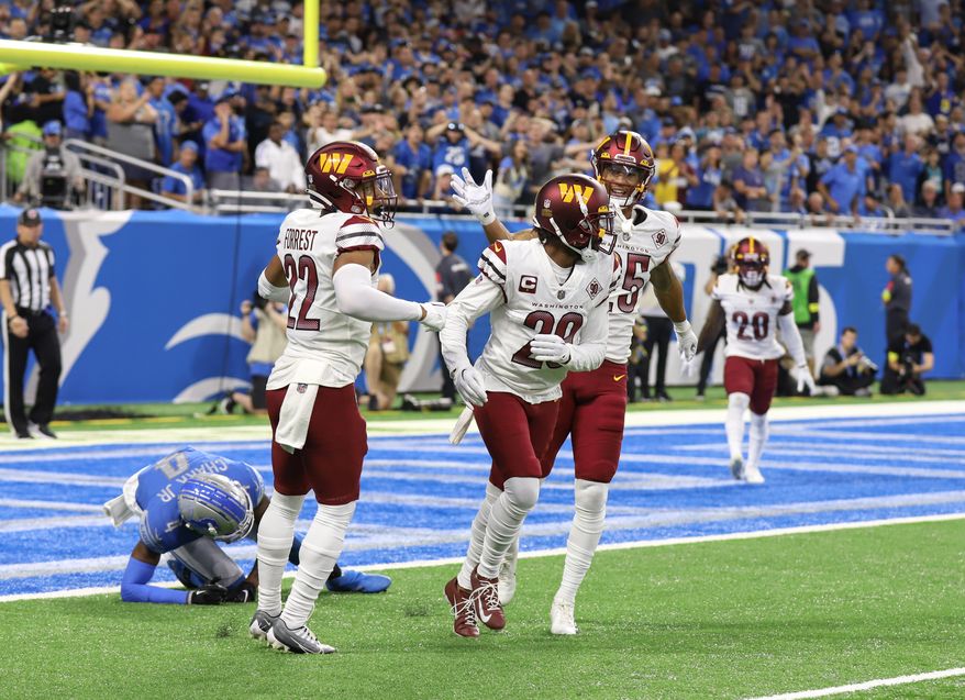 Washington Commanders&#39; CB Kendall Fuller (28) being pat on the back by teammate Benjamin St-Juste (25) and Safety Darrick Forrest (22) after breaking up a pass at the Commanders vs the Detroit Lions at Ford Field in Detroit Michigan on September 18th 2022 (Photo: Alyssa Howell)