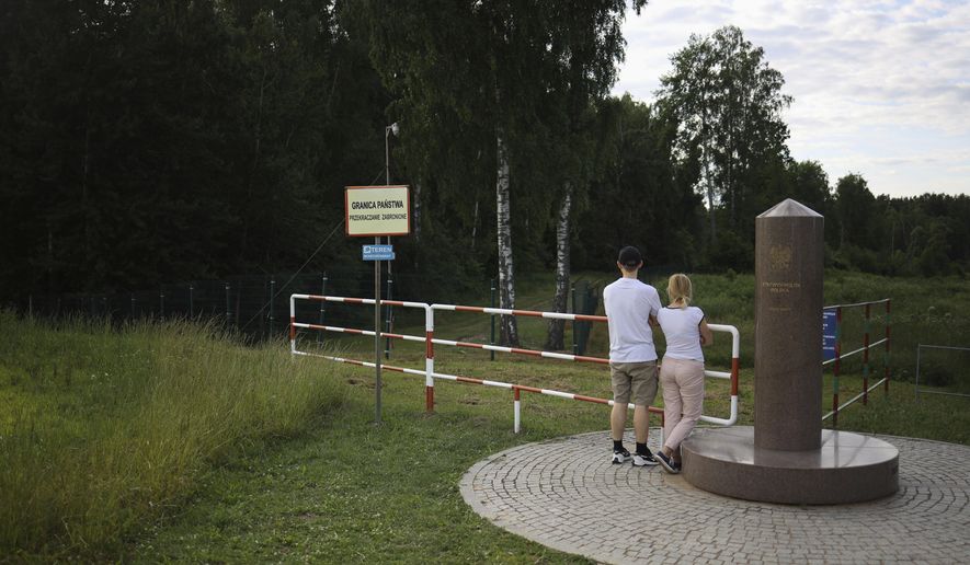 People visit the area of tripoint marking the place where borders of Poland, Lithuania and Russia&#39;s Kaliningrad Oblast meet, in Zerdziny, Poland, July 7, 2022. Estonia, Latvia and Lithuania closed their borders Monday, Sept. 19, 2022, to most Russian citizens in response to the wide domestic support in Russia for the war in Ukraine. Under the coordinated travel ban, Russians wishing to travel to the Baltic countries or Poland as tourists or for business, sports or cultural purposes will not be allowed in even if they hold valid visas for the European Union&#39;s checks-free Schengen Area. (AP Photo/Michal Dyjuk, File)