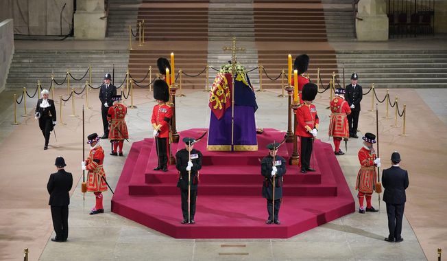 Black Rod walks through Westminster Hall at 06:29am to pay respect on the final day of the lying in state at the coffin of Queen Elizabeth II, draped in the Royal Standard with the Imperial State Crown and the Sovereign&#x27;s orb and sceptre, lying in state on the catafalque in Westminster Hall, at the Palace of Westminster in London Monday, Sept. 19, 2022. (Yui Mok/Pool Photo via AP)