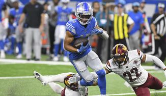 Detroit Lions wide receiver Amon-Ra St. Brown (14) runs after making a catch during the first half of an NFL football game against the Washington Commanders Sunday, Sept. 18, 2022, in Detroit. (AP Photo/Lon Horwedel)