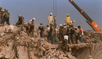 Rescue workers sift through the rubble of the U.S. Marine base in Beirut in Oct. 23, 1983 following a massive bomb blast that destroyed the base and killed 241 American servicemen. Iran told the United Nation’s highest court on Monday, Sept. 19, 2022, that Washington’s confiscation of some $2 billion in assets from Iranian state bank accounts to compensate bombing victims was an attempt to destabilize the Iranian government and a violation of international law. The U.S. Supreme Court in 2016 ruled money held in Iran’s central bank could be used to compensate victims of the 1983 bombing linked to Iran. (AP Photo, File)