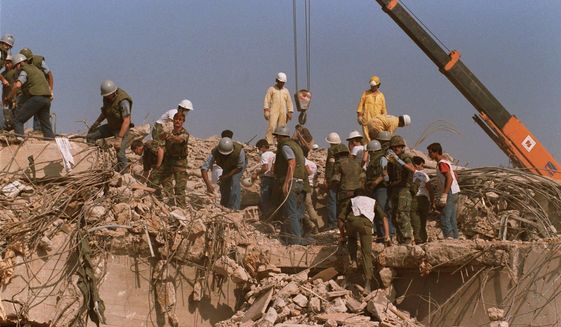 Rescue workers sift through the rubble of the U.S. Marine base in Beirut in Oct. 23, 1983 following a massive bomb blast that destroyed the base and killed 241 American servicemen. Iran told the United Nation’s highest court on Monday, Sept. 19, 2022, that Washington’s confiscation of some $2 billion in assets from Iranian state bank accounts to compensate bombing victims was an attempt to destabilize the Iranian government and a violation of international law. The U.S. Supreme Court in 2016 ruled money held in Iran’s central bank could be used to compensate victims of the 1983 bombing linked to Iran. (AP Photo, File)