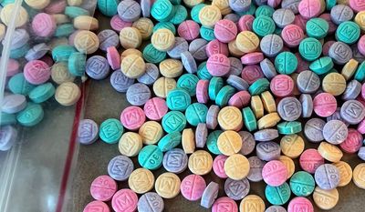 Two New York City men were charged after the Drug Enforcement Administration seized 300,000 rainbow-colored fentanyl pills and 22 pounds of powdered fentanyl worth $9 million, and an assault weapon, from a Bronx apartment. (DEA photo)