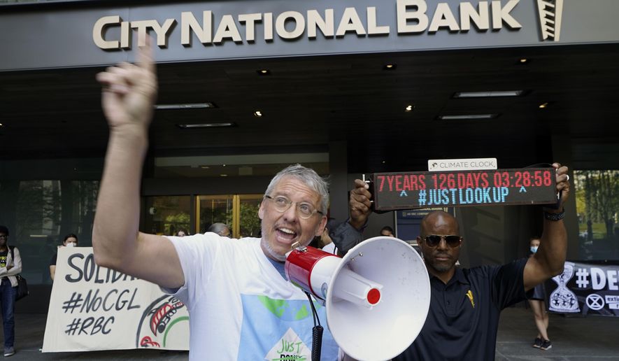 Adam McKay, left, director of the film &amp;quot;Don&#39;t Look Up,&amp;quot; joins members of the Youth Climate Los Angeles coalition and others protesting climate change outside City National Bank in Los Angeles, Friday, March 18, 2022. On Tuesday Sept. 20, 2022, McKay announced a $4 million donation to the Climate Emergency Fund, an organization dedicated to getting money into the hands of activists engaged in disruptive, nonviolent demonstrations urging swifter action on climate change. (AP Photo/Damian Dovarganes, File)