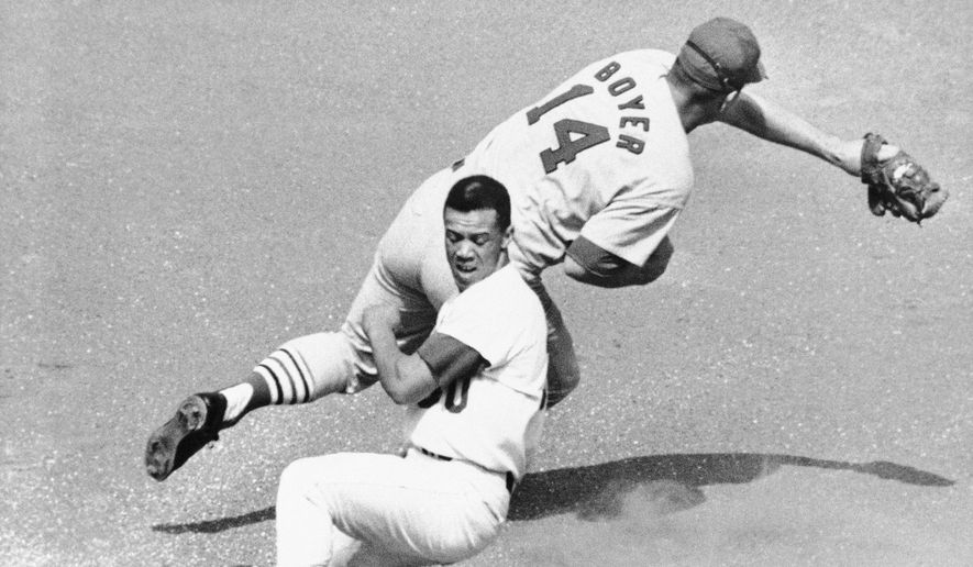 Los Angeles Dodgers&#39; Maury Wills is safe at third as St. Louis Cardinals&#39; Ken Boyer takes the throw during the first inning of a baseball game in Los Angeles, Sept. 26, 1965. Maury Wills, who helped the Los Angeles Dodgers win three World Series titles with his base-stealing prowess, has died. The team says Wills died Monday night, Sept. 19, 2022, in Sedona, Ariz. He was 89.  (AP Photo/FW) **FILE**