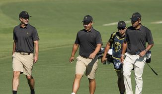 Adam Scott, of Australia, Tom Kim and Hideki Matsuyama, of Japan, walk up the fifth fairway during practice for the Presidents Cup golf tournament at the Quail Hollow Club, Tuesday, Sept. 20, 2022, in Charlotte, N.C. (AP Photo/Chris Carlson)