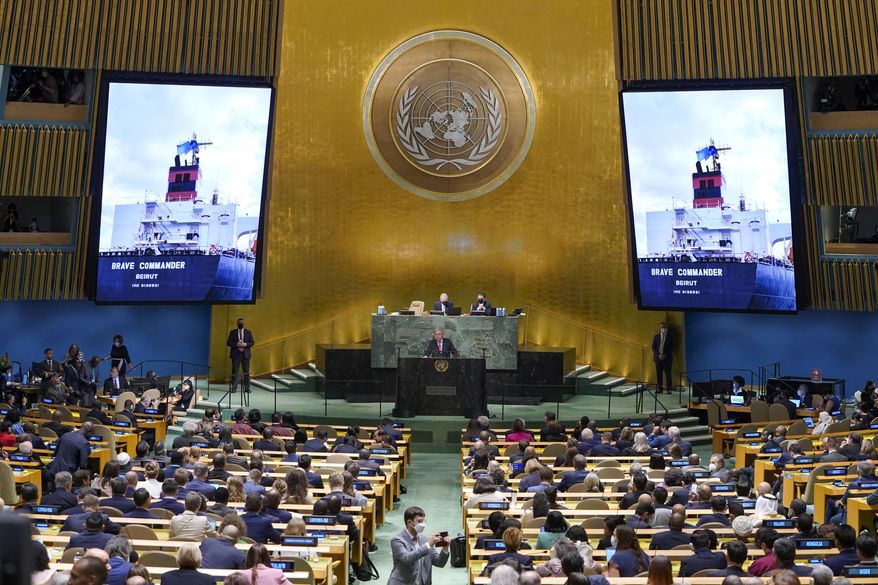 An image of the &#39;Brave Commander&#39; ship carrying grain from Ukraine is displayed on screens as Secretary-General António Guterres addresses the 77th session of the General Assembly at United Nations headquarters Tuesday, Sept. 20, 2022. (AP Photo/Mary Altaffer)