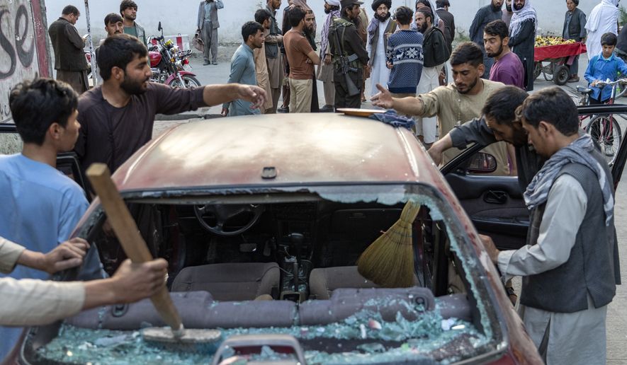 People clean a car that was damaged by an explosion, in Kabul, Afghanistan, Wednesday, Sept. 21, 2022. The Taliban say at least three people have been killed and 13 others wounded in an explosion in the Afghan capital. The Taliban-appointed spokesman for Kabul&#39;s police chief said Wednesday the explosion occurred in a restaurant in the city&#39;s Dehmazang neighborhood. (AP Photo/Ebrahim Noroozi)