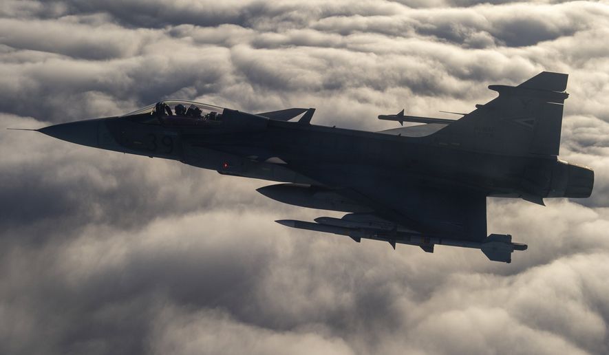 A JAS-39 Gripen fighter jets of the Hungarian Air Force fly during a demonstration flight in the airspace of Lithuania, Wednesday, September 21, 2022. The Hungarian air force leads the Baltic Air Policing mission of NATO granting air defence service for the three Baltic states, Estonia, Latvia and Lithuania for the third time from 01 August for four months. (Sandor Ujvari/MTI via AP)