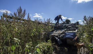 Local resident Oleksandr looks at a damaged Russian tank near his ruined house in the recently retaken area close to Izium, Ukraine, Wednesday, Sept. 21, 2022. Residents of Izium and villages around it recaptured in a recent Ukrainian counteroffensive that swept through the Kharkiv region, are emerging from the confusion and trauma of six months of Russian occupation, the brutality of which gained worldwide attention last week after the discovery of one of the world&#39;s largest mass grave sites. (AP Photo/Oleksandr Ratushniak)