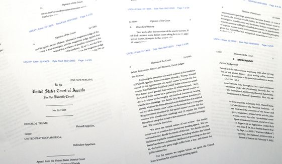 Pages from a U.S. Court of Appeals for the 11th Circuit in Atlanta ruling that lifts a judge&#39;s hold on the Justice Department&#39;s ability to use classified documents seized by the FBI at Trump&#39;s Mar-a-Lago estate, are photographed Wednesday, Sept. 21, 2022. The ruling clears the way for the department to immediately resume its use of the documents in its investigation.(AP Photo/Jon Elswick)
