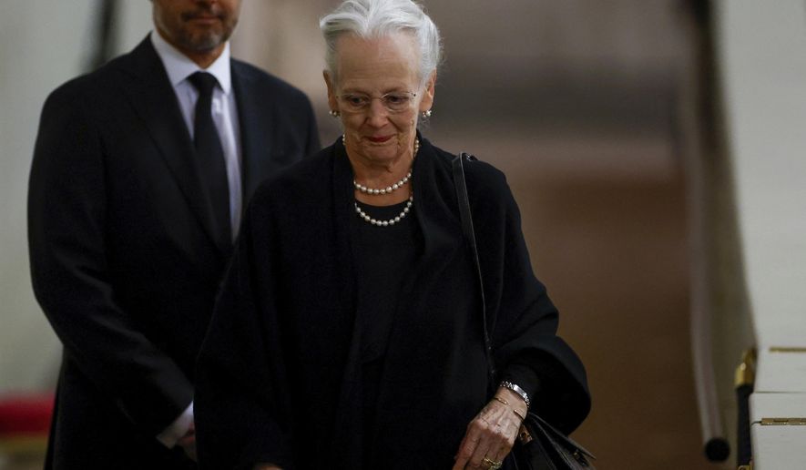 Denmark&#39;s Queen Margrethe pays her respect to the coffin of Britain&#39;s Queen Elizabeth, following her death, during her lying-in-state at Westminster Hall, in London, Sunday Sept. 18, 2022. Denmark’s Queen Margrethe II has tested positive for the coronavirus after attending the funeral of Britain’s Queen Elizabeth II. The Danish royal palace said Wednesday, Sept. 21, 2022 that the 82-year-old Margrethe canceled her official duties after the Tuesday night test. she previously tested positive for the virus in February. (John Sibley/Pool via AP, File)