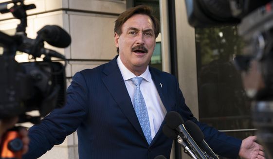 MyPillow chief executive Mike Lindell speaks to reporters outside federal court in Washington, Thursday, June 24, 2021. On Tuesday, Sept. 13, 2022, Lindell said that federal agents seized his cellphone and questioned him about a Colorado clerk who has been charged in what prosecutors say was a “deceptive scheme” to breach voting system technology used across the country. (AP Photo/Manuel Balce Ceneta, File)