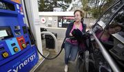 Jennifer Quinn fills her SUV at a gas station Monday, March 7, 2022, in Needham, Mass. The average price of regular gasoline nationwide is up slightly Wednesday, Sept. 21, from a day earlier, the first time prices have climbed in 99 days. (AP Photo/Steven Senne) ** FILE **