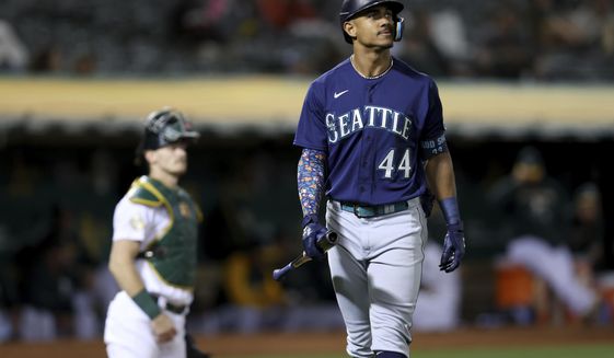 Seattle Mariners&#39; Julio Rodriguez (44) walks back to the dugout after striking out against the Oakland Athletics during the fifth inning of a baseball game in Oakland, Calif., Tuesday, Sept. 20, 2022. (AP Photo/Jed Jacobsohn)