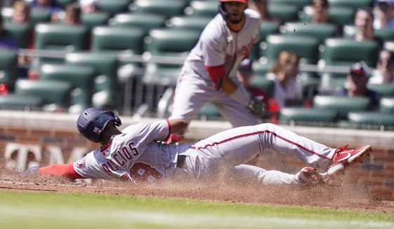 Washington Nationals&#39; Josh Palacios (68) slides safely home in the fifth inning of a baseball game against the Atlanta Braves, Wednesday, Sept. 21, 2022, in Atlanta. (AP Photo/Brynn Anderson)
