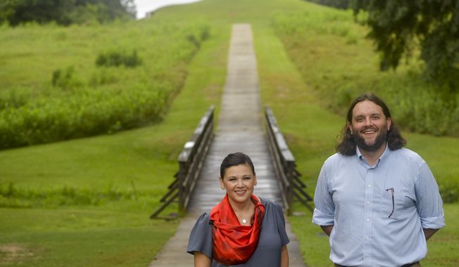 Tracie Revis, left, a citizen of the Muscogee Creek Nation, and Seth Clark, mayor pro-tem of Macon, stand at the approach to the Earth Lodge, where Native Americans held council meetings for 1,000 years until their forced removal in the 1820s, on Aug. 22, 2022, in Macon, Ga. Revis and Clark are co-directors of an initiative to bring 50 miles of the Ocmulgee River under federal protection as a national park. (AP Photo/Sharon Johnson)
