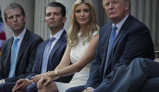 Donald Trump, right, sits with his children, from left, Eric Trump, Donald Trump Jr., and Ivanka Trump during a groundbreaking ceremony for the Trump International Hotel on July 23, 2014, in Washington. New York’s attorney general sued former President Donald Trump and his company on Wednesday, Sept. 21, 2022, alleging business fraud involving some of their most prized assets, including properties in Manhattan, Chicago and Washington, D.C. (AP Photo/Evan Vucci) **FILE**