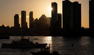 NYPD and Coast Guard boats patrol the East River outside the United Nations headquarters, Wednesday, Sept. 21, 2022, in New York. (AP Photo/Julia Nikhinson)
