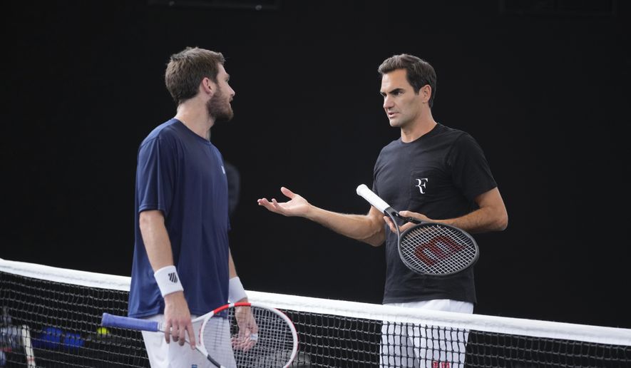 Switzerland&#39;s Roger Federer, right, chats with Cameron Norris, of Great Britain during a training session ahead of the Laver Cup tennis tournament at the O2 in London, Wednesday, Sept. 21, 2022. Federer appeared earlier at a news conference to discuss his retirement from professional tennis at age 41 after a series of knee operations. He will close his career with a doubles match at the Laver Cup on Friday. (AP Photo/Kin Cheung) **FILE**