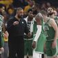FILE - Boston Celtics head coach Ime Udoka, center left, talks with players during the first half of Game 2 of basketball&#39;s NBA Finals against the Golden State Warriors in San Francisco, Sunday, June 5, 2022. The Boston Celtics are planning to discipline coach Ime Udoka, likely with a suspension, because of an improper relationship with a member of the organization, two people with knowledge of the matter told The Associated Press on Thursday, Sept. 22, 2022. (AP Photo/Jed Jacobsohn, File)
