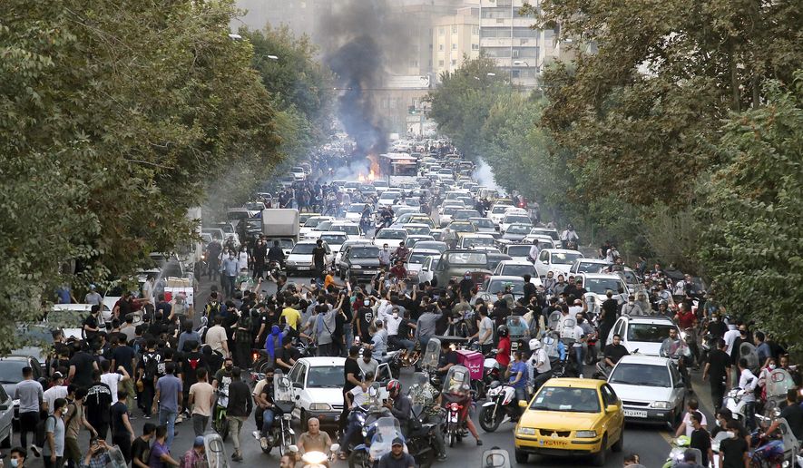 In this photo taken by an individual not employed by the Associated Press and obtained by the AP outside Iran, protesters chant slogans during a protest over the death of a woman who was detained by the morality police, in downtown Tehran, Iran, Sept. 21, 2022.  (AP Photo, File)