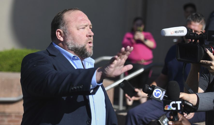 Alex Jones speaks to the media before entering court for day five of the Sandy Hook defamation damages trial at Connecticut Superior Court in Waterbury, Conn., Tuesday, Sept. 20, 2022. Seven days into his trial for calling the Sandy Hook school shooting a hoax, Jones is expected make his first courtroom appearance and begin testifying Thursday, Sept. 22 as he and his lawyer try to limit damages he must pay to families who lost loved ones in the massacre. (Tyler Sizemore/Hearst Connecticut Media via AP, File)