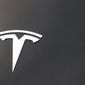 FILE - The Tesla company logo is seen on the hood of an unsold vehicle at a dealership, Sunday, Aug. 9, 2020, in Littleton, Colo. Tesla is recalling nearly 1.1 million vehicles in the U.S. because the windows can pinch a person’s fingers when being rolled up. Tesla says in documents posted Thursday, Sept. 22, 2022 by U.S. safety regulators that the automatic window reversal system may not react correctly after detecting an obstruction.  (AP Photo/David Zalubowski, File)
