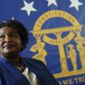 FILE - Democratic candidate for Georgia Governor Stacey Abrams poses for a portrait in front of the State Seal of Georgia on Aug. 8, 2022, in Decatur, Ga. On Friday, Sept. 23, 2022, the state Accounting Office reported that Georgia ran a surplus of more than $6 billion in the budget year that ended June 30, meaning the state&#39;s next governor and lawmakers could spend or give back billions. (AP Photo/John Bazemore, File)
