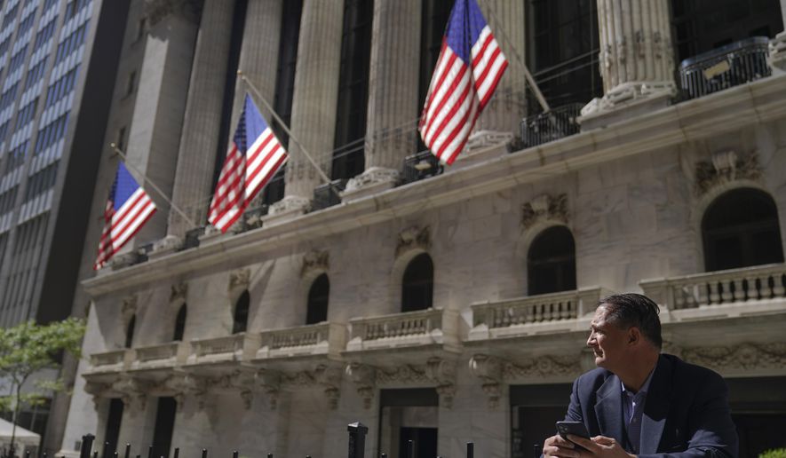A trader stands outside the New York Stock Exchange, Friday, Sept. 23, 2022, in New York. Stocks tumbled worldwide Friday on more signs the global economy is weakening, just as central banks raise the pressure even more with additional interest rate hikes. (AP Photo/Mary Altaffer)