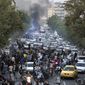 In this photo taken by an individual not employed by the Associated Press and obtained by the AP outside Iran, protesters chant slogans during a protest over the death of a woman who was detained by the morality police, in downtown Tehran, Iran, Wednesday, Sept. 21, 2022. (AP Photo)
