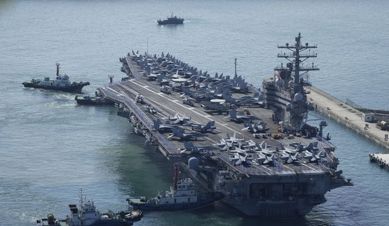 The U.S. carrier USS Ronald Reagan is escorted as it arrives in Busan, South Korea, Friday, Sept. 23, 2022. The nuclear-powered aircraft carrier arrived in Busan port on Friday ahead of the two countries&#39; joint military exercise that aims to show their strength against growing North Korean threats. (AP Photo/Lee Jin-man)
