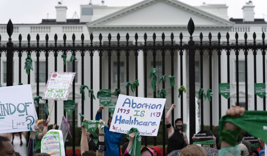 Abortion-rights demonstrators shout slogans after tying green flags to a fence at the White House during a protest to pressure the Biden administration to act and protect abortion rights, in Washington, July 9, 2022. Democrats are leaning into messaging strategy from pro-abortion rights groups, who have long advised candidates and elected officials to talk about reproductive rights. (AP Photo/Jose Luis Magana, File)