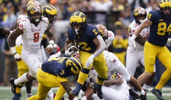 Michigan running back Blake Corum (2) runs the ball against Maryland in the first half of an NCAA college football game in Ann Arbor, Mich., Saturday, Sept. 24, 2022. (AP Photo/Paul Sancya)