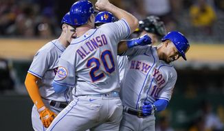 New York Mets&#39; Eduardo Escobar, right, celebrates with Pete Alonso after hitting a grand slam against the Oakland Athletics during the fifth inning of a baseball game in Oakland, Calif., Friday, Sept. 23, 2022. (AP Photo/Godofredo A. Vásquez)