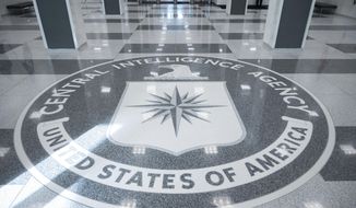 The seal of Central Intelligence Agency is seen in the lobby the headquarters building in Langley, Va., on Saturday, Sept. 24, 2022. (AP Photo/Kevin Wolf)