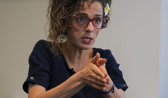 Iranian dissident Masih Alinejad gestures as she speaks during an interview with The Associated Press, Friday, Sept. 23, 2022, in New York. (AP Photo/Mary Altaffer)