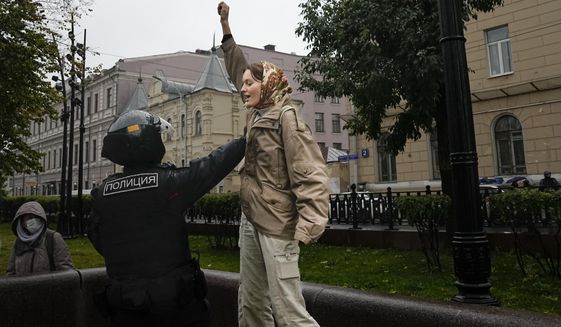 A Police officer detains a demonstrator during a protest against a partial mobilization in Moscow, Russia, Saturday, Sept. 24, 2022. (AP Photo)